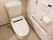 トイレは、全面が白色で統一されたデザインの室内となっている。温水洗浄便座仕様で壁に操作パネルや手すり、ナースコールがある。