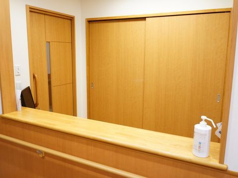 手前にはカウンターがあり、そこの右側には消毒液が置かれている。下側には手すりが付いている。左下にはコンセントがある。