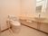 洗面台や鏡が設置されたトイレである。トイレには手すりが設置されているため、安全に便座へ移動することができる。