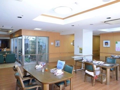 リビング内にはテーブルと椅子が置かれており、座りながら窓越しに坪庭を眺めることができる。壁や床は木製である。