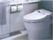 グループホーム松花園のトイレ。手すりがついたウォシュレットトイレを完備している。