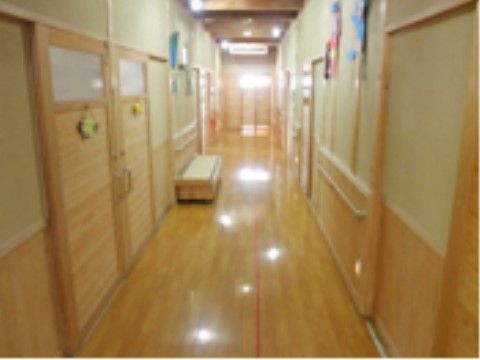 木材を使った腰板が備え付けられた通路である。扉も木材を使用しており、リラックスして過ごせる空間が広がっている。