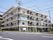 閑静な住宅街の角地に立地している陽当たりの良い5階建ての施設の外観。建物の周りには木々が植えられている。