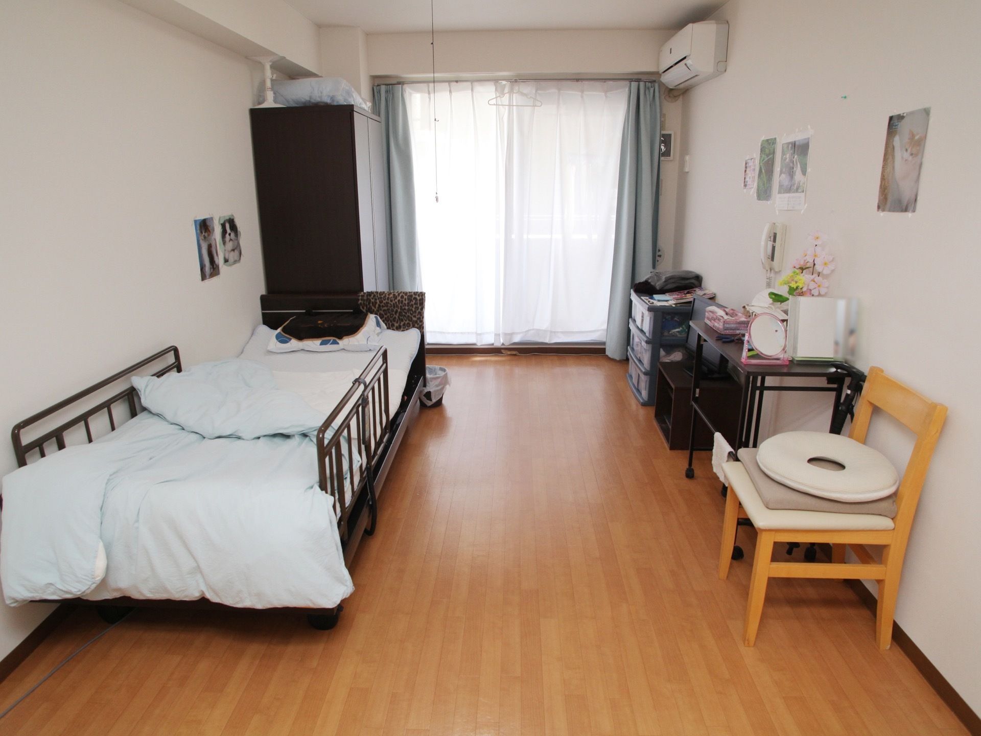 居室は大きな窓があり、明るく広々としている。ベッドとクローゼット、椅子などが置かれ、エアコンが設置されている。