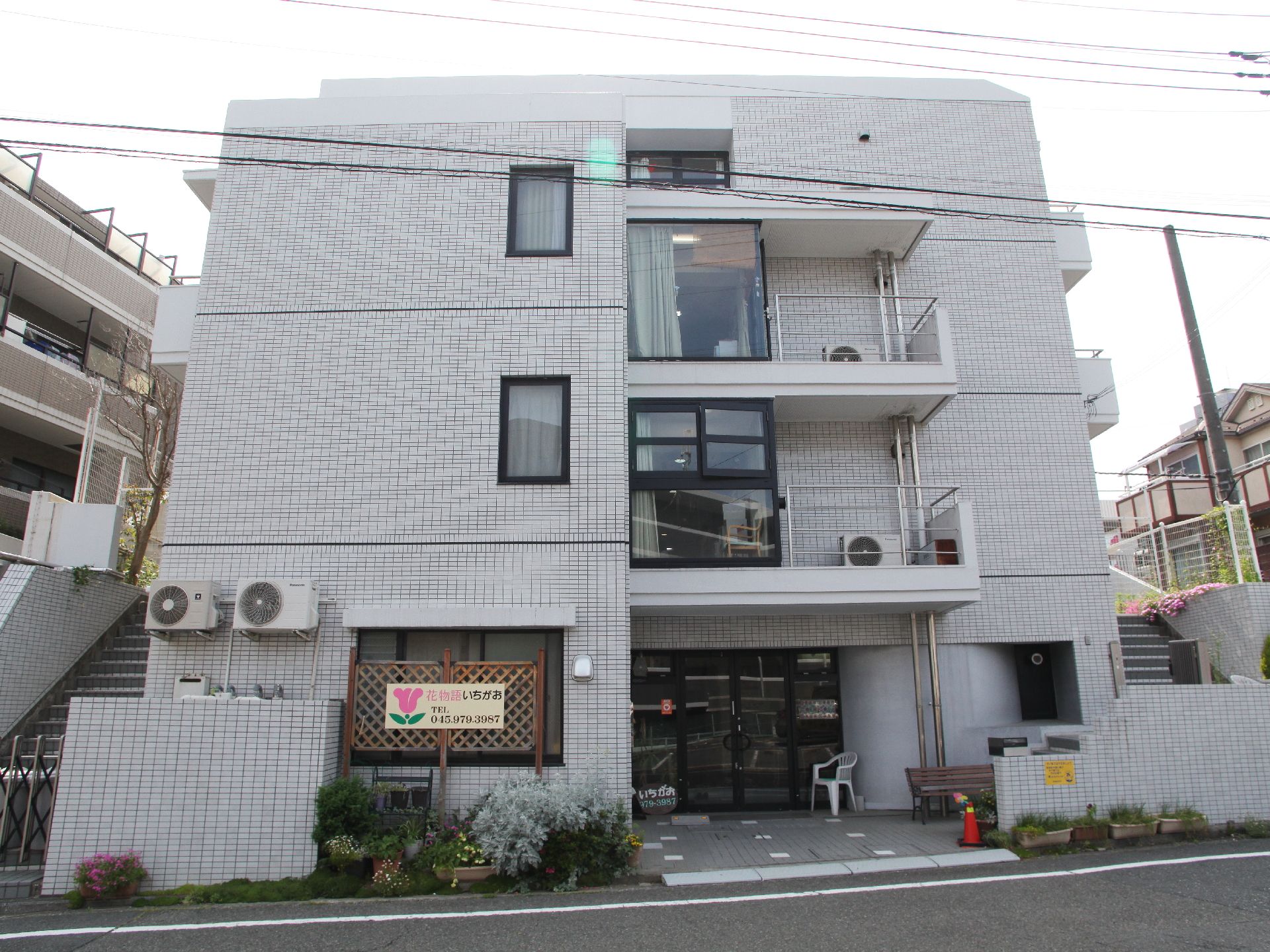 両脇に階段があり、通りに面した開けたスペースに建てられた3階建ての施設