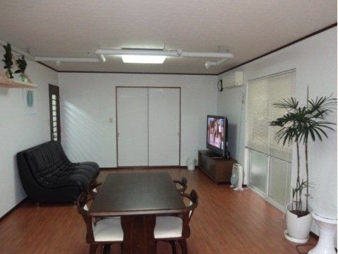 テレビとソファー、4人掛けのテーブルが設置された共有スペース