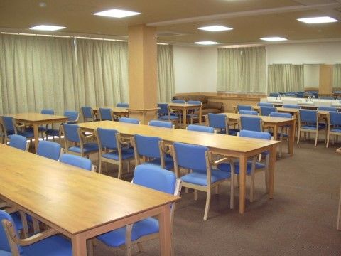 青い椅子が多く置かれた共有スペース