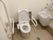 施設内にある、トイレのひとつ。トイレには、手すりが設置されている。また、同じ個室内にオストメイトが併設されている。