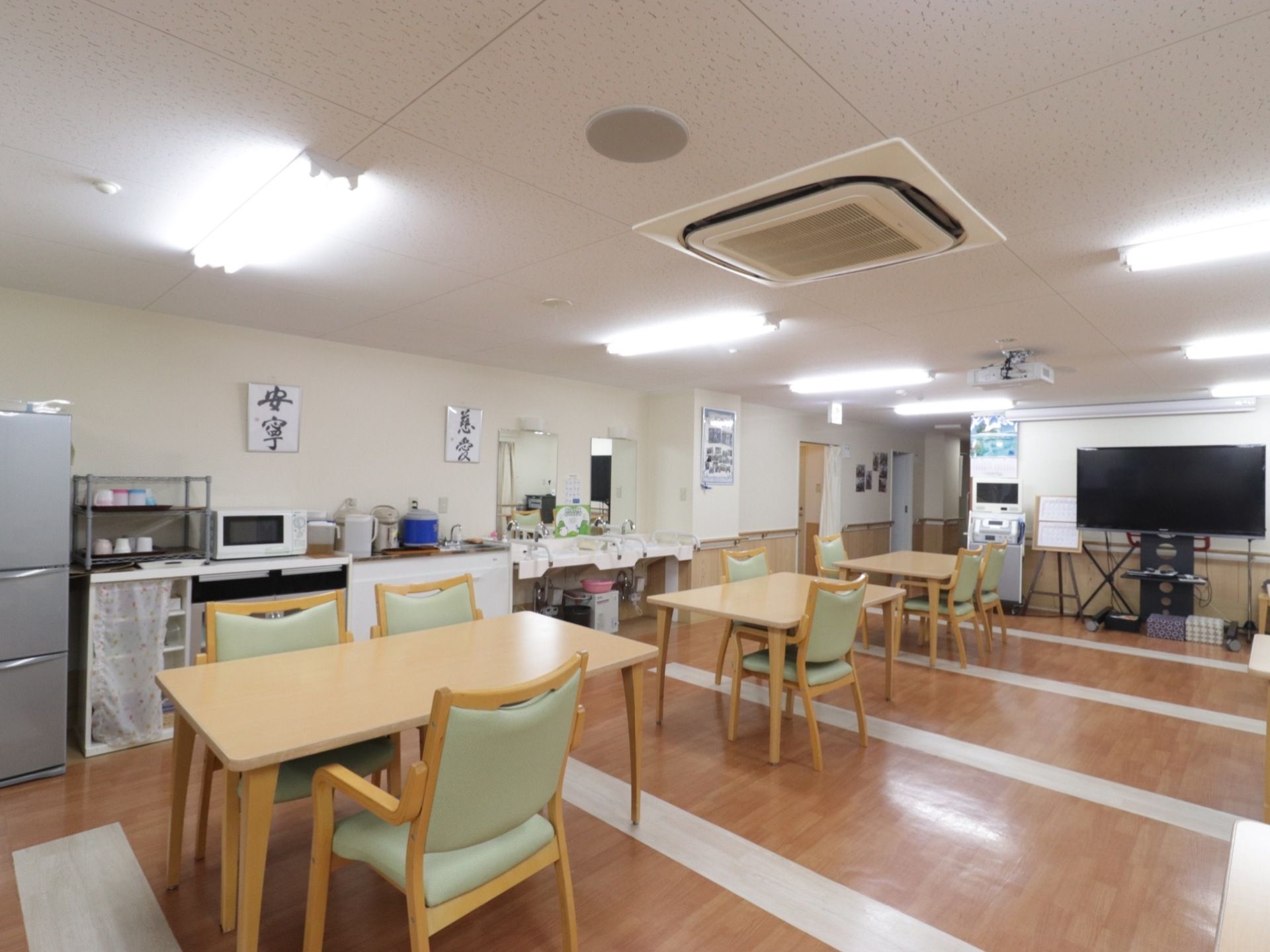 食堂には大きなテレビがある。天井にはプロジェクターがあり、壁に設置された大きなスクリーンで映像を楽しむことができる。