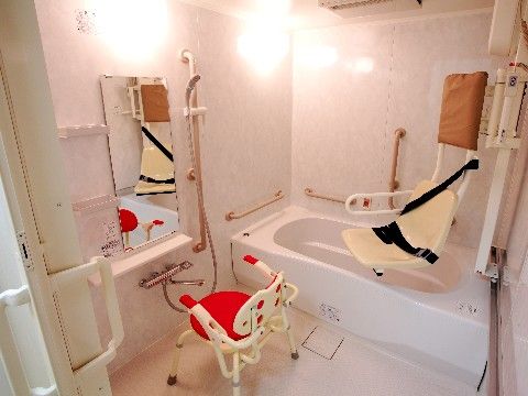赤いシャワーチェアが置いてある、機械浴ができる浴室