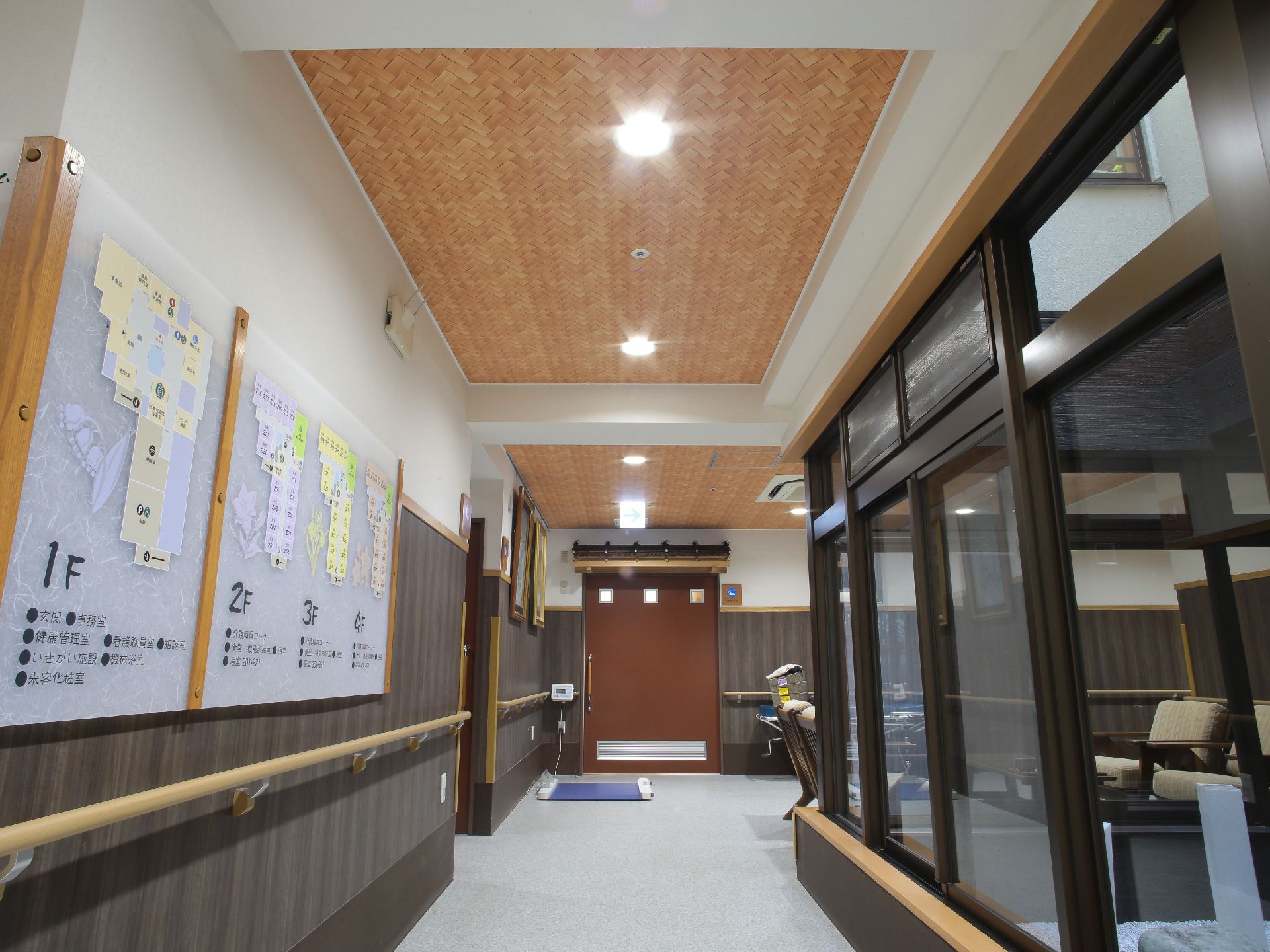 各階の見取り図と案内が書いてある看板が壁に取り付けてある。廊下の角を曲がったところにアームチェアとコーヒーテーブルが置いてある。
