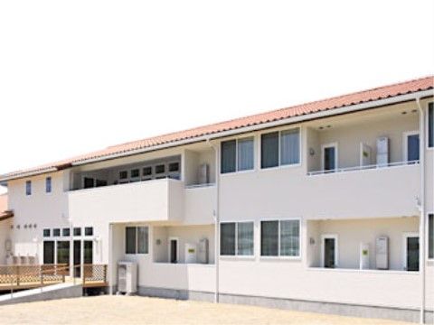 施設は、白い外壁の明るい雰囲気の建物である。各居室にベランダがあるので、手軽に外の風を感じることができる。