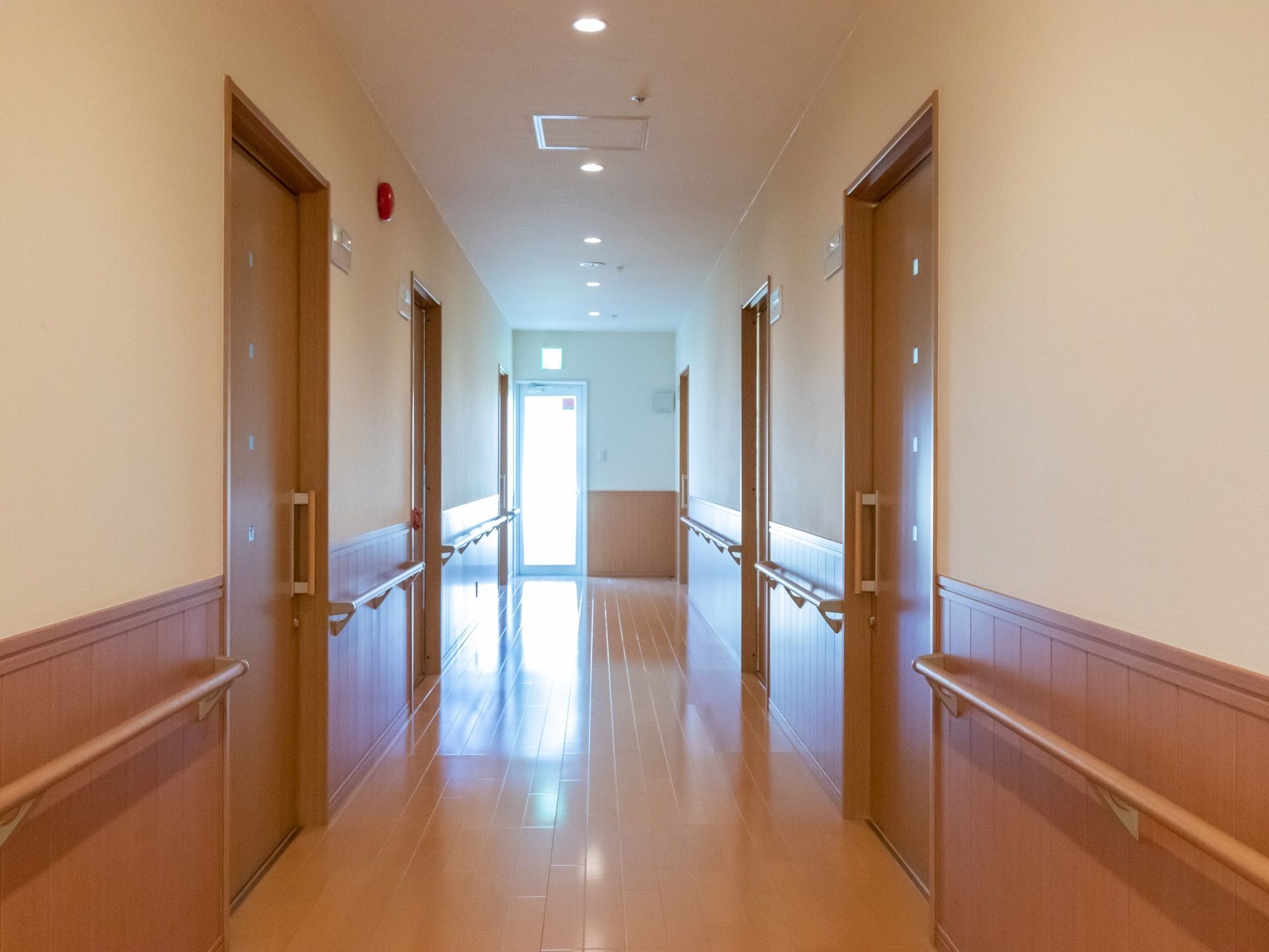 居室前の廊下で、突き当たりには非常扉が設けられている。両サイドの壁には、手すりが取り付けられている。