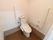 白を基調としたトイレで清潔感がある。壁にはＬ型の手摺が設置されている。便器には可動式の物も付けられている。