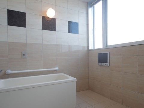 採光十分な明るい浴室には手すりが設置され、安全にご入浴いただける。浴室テレビでテレビ番組もお楽しみいただける。