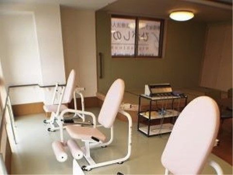明るい窓際に複数のリハビリ機器が置かれている機能訓練室