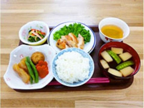 メインの肉料理に２種類の副菜、白米に汁物が並べられたボリュームのある食事