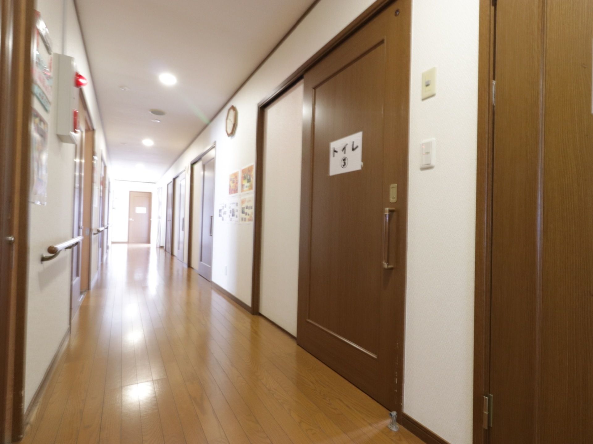 廊下には居室などの扉が設置されている。引き戸になっているので安全に開閉することができる。火災報知器を設置しており緊急時も安心である。