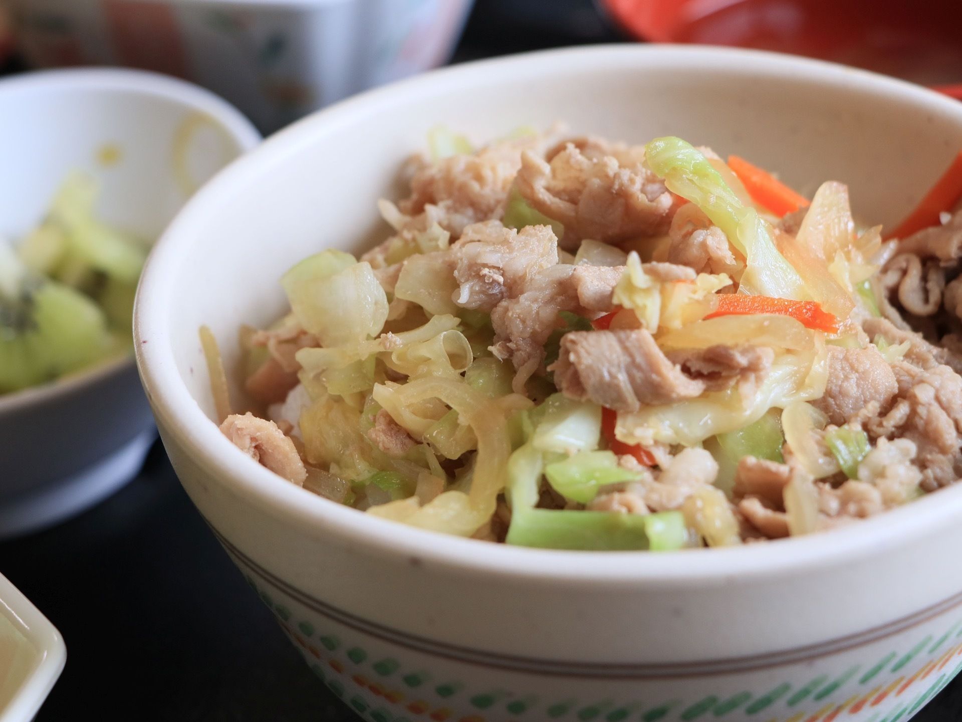 ある日の食事メニューの一品である。食べやすいよう細かくカットされ、調理された主菜が器に盛りつけされている。