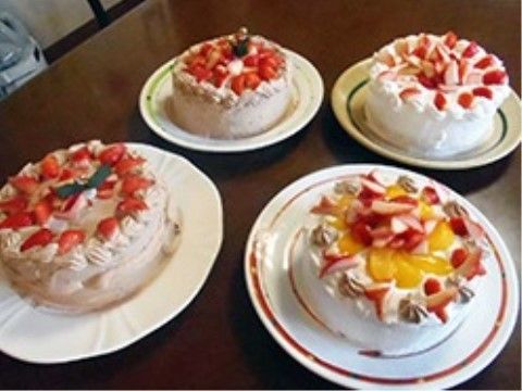 フルーツがたっぷりと載せられている４つのホールケーキ