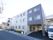 3階建てのサービス付高齢者向け住宅。玄関前に駐車スペースが設けられている。周りには大型ショッピングセンターがあり、利便性に優れている。