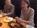 グループホームひかりのイベント食。外食でハンバーグを食べる入居者様。