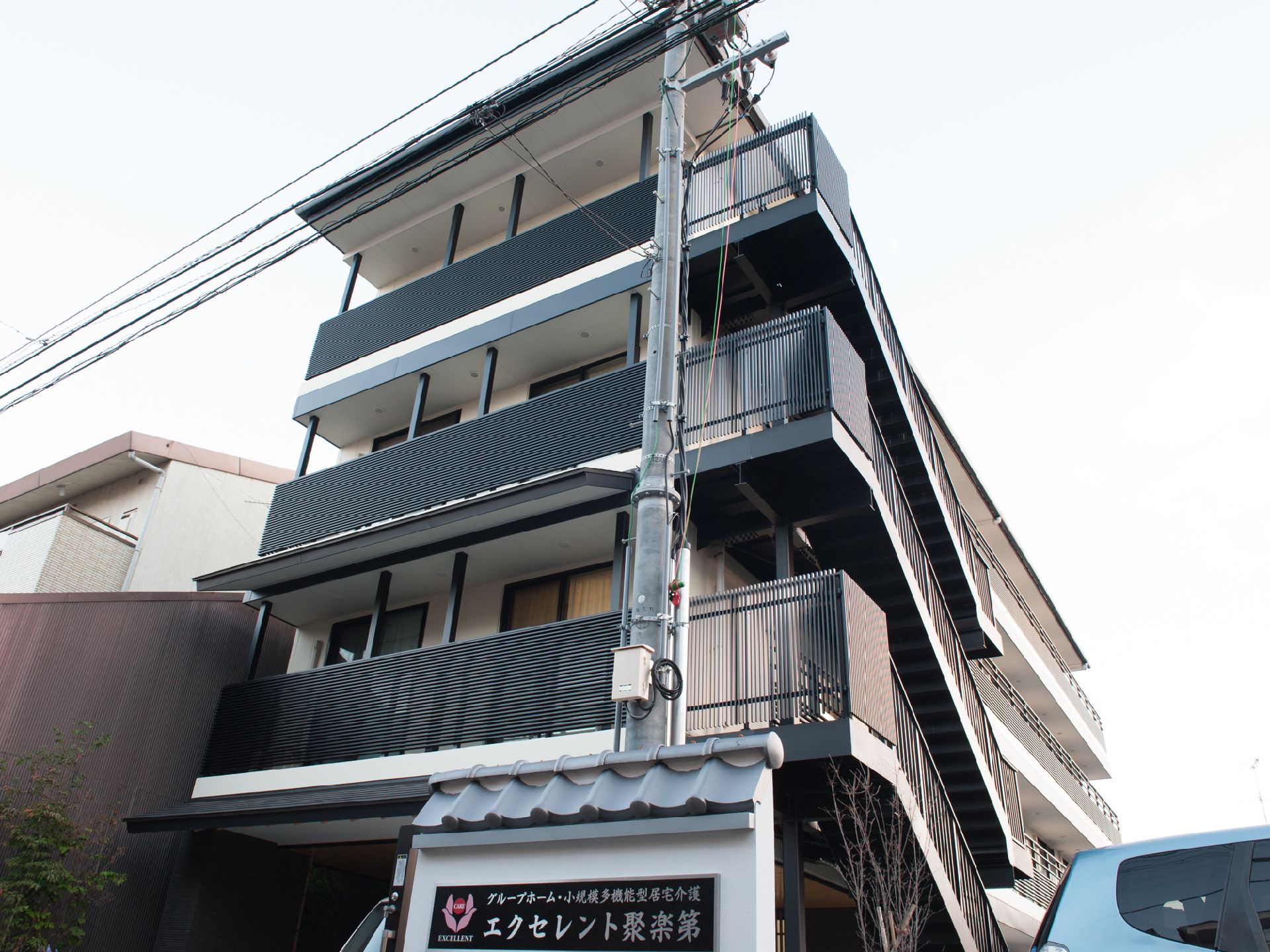 1階正面には、建物名を大きく表示。ベランダ、階段には黒が使われていて、落ち着いた雰囲気の外観になっている。