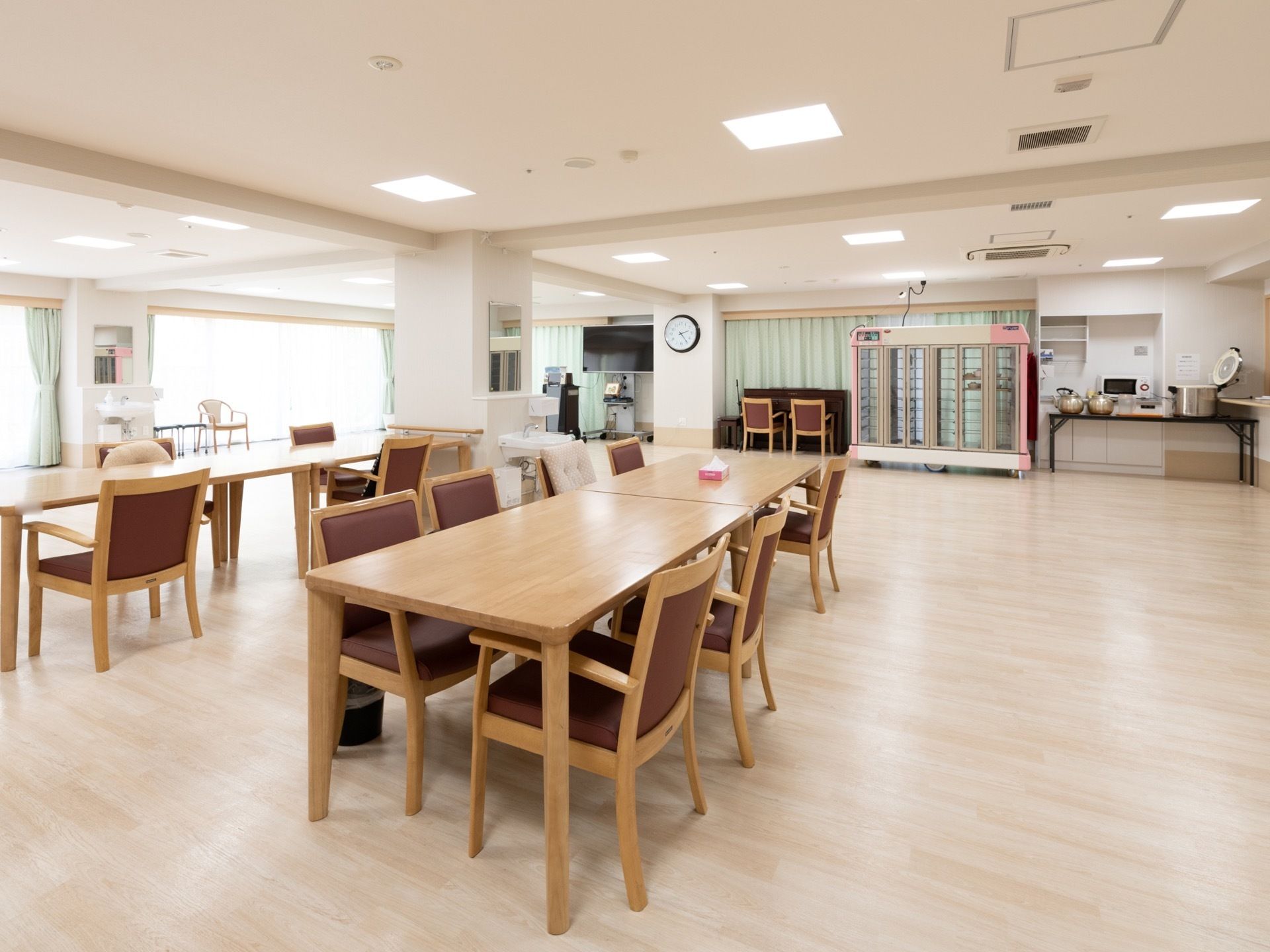 広々とした食堂には複数のテーブル、椅子が並べられている。食堂の壁側や柱のある場所に洗面台が設置されている。