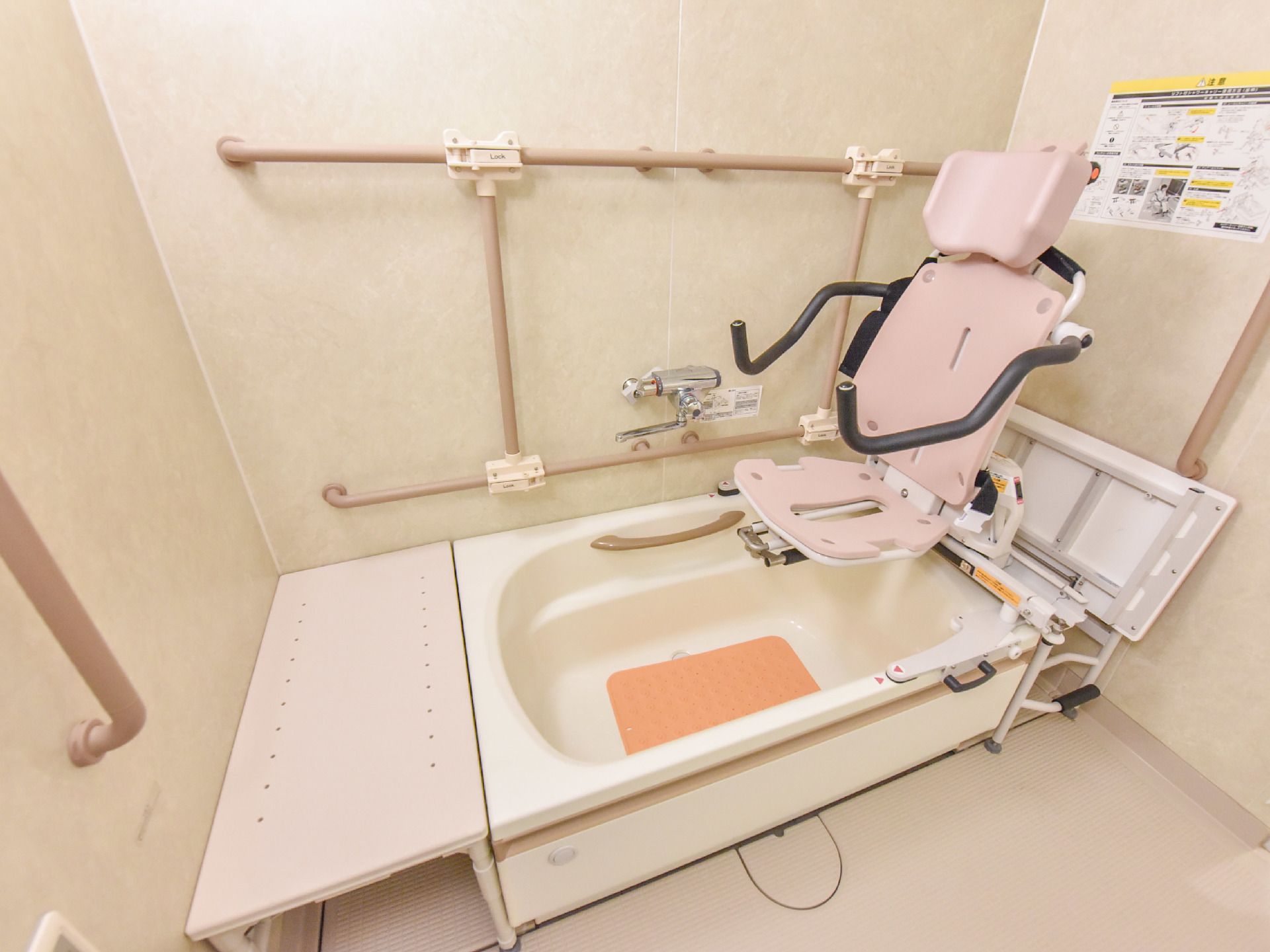 身体の不自由な方でも入れる浴槽がある。電動式の昇降椅子が設置されている他、高さの違う手すりも設置されている。