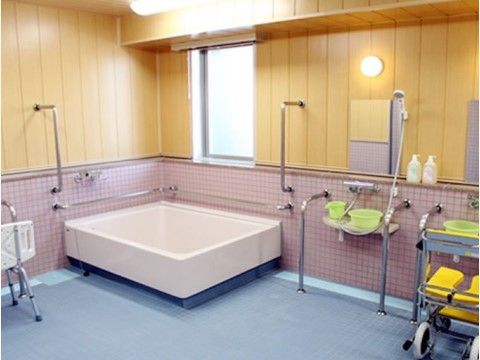 広いスペースが確保されている浴室。手すりがたくさんついており、移動が安全にできる。シャワーと蛇口が高い位置に設置されている。