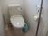 トイレは共用となっており、立ち上がり用の手すり代わりのポールがある。室内には掃除用具や洗剤が常備されている。
