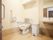 暖房便座付きトイレがあり、壁や便座周囲には手すりが取りつけられている。洗面台も同じスペースに確保されている。