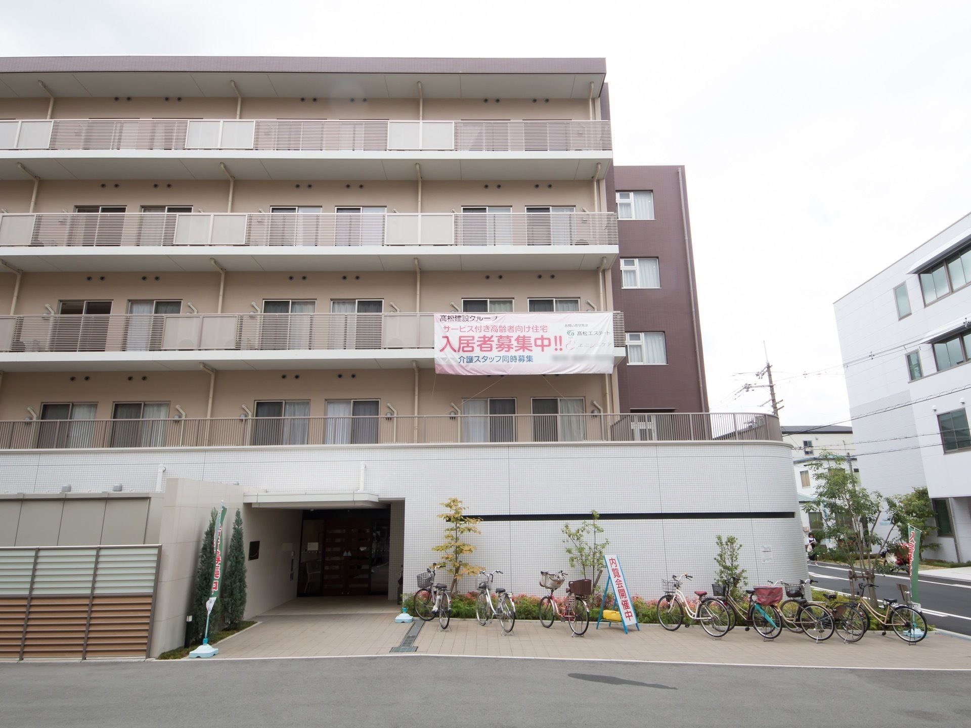淡い茶ベースの落ち着いた雰囲気の施設外観。各居室には見通しのよい広々としたベランダが設置されており、洗濯物などを干すことができる。