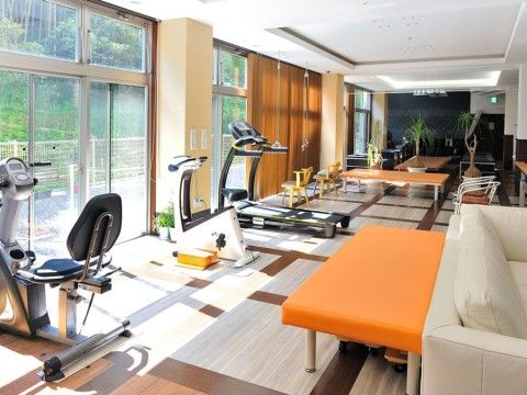 窓に向かってランニングマシンやエアロバイクが並ぶトレーニングルーム