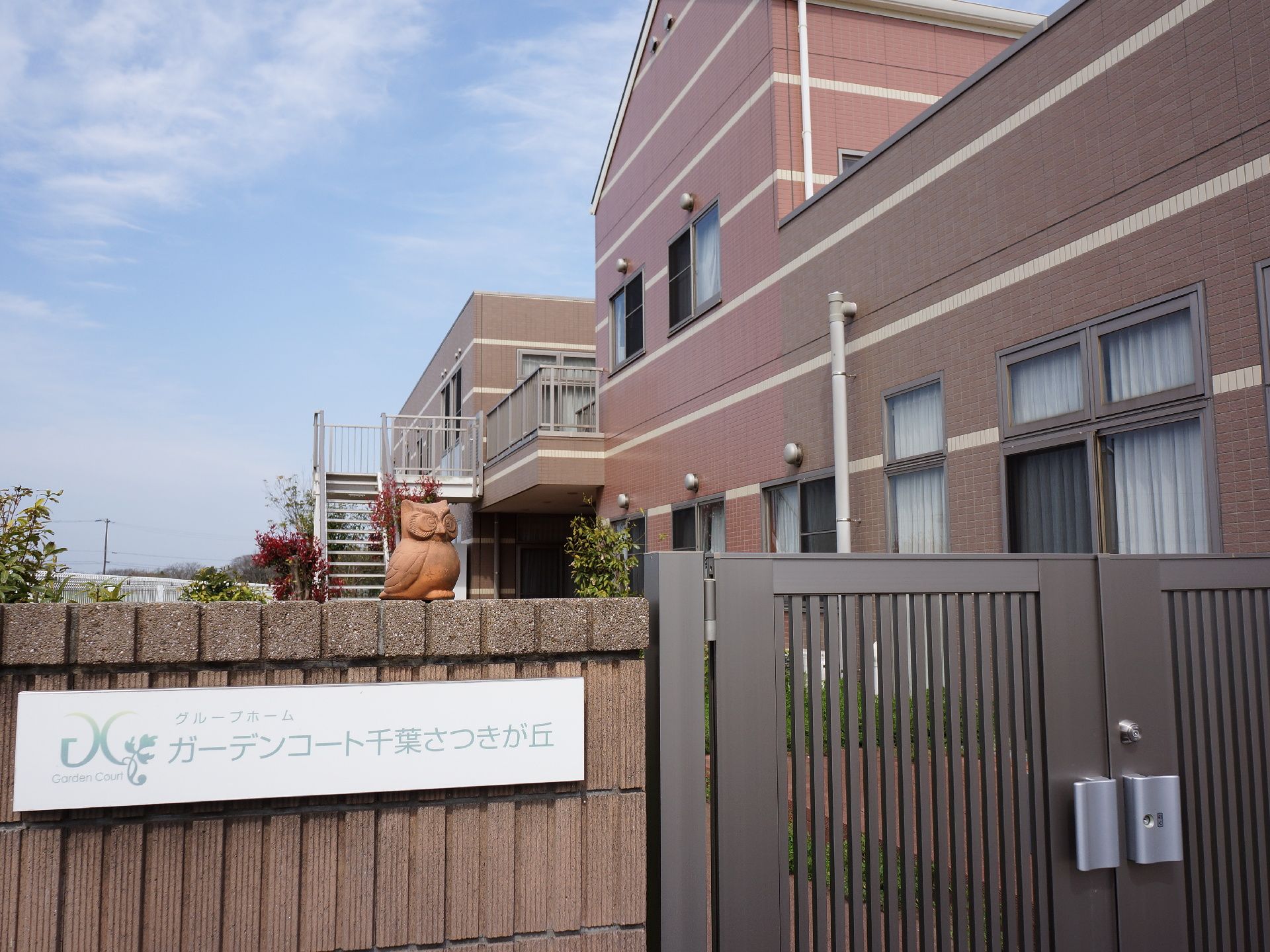 玄関前には不審者対応として、頑丈な門扉が設置されている。その上には、可愛らしいフクロウの置物もあり、ご利用者様が心和む雰囲気も出している。