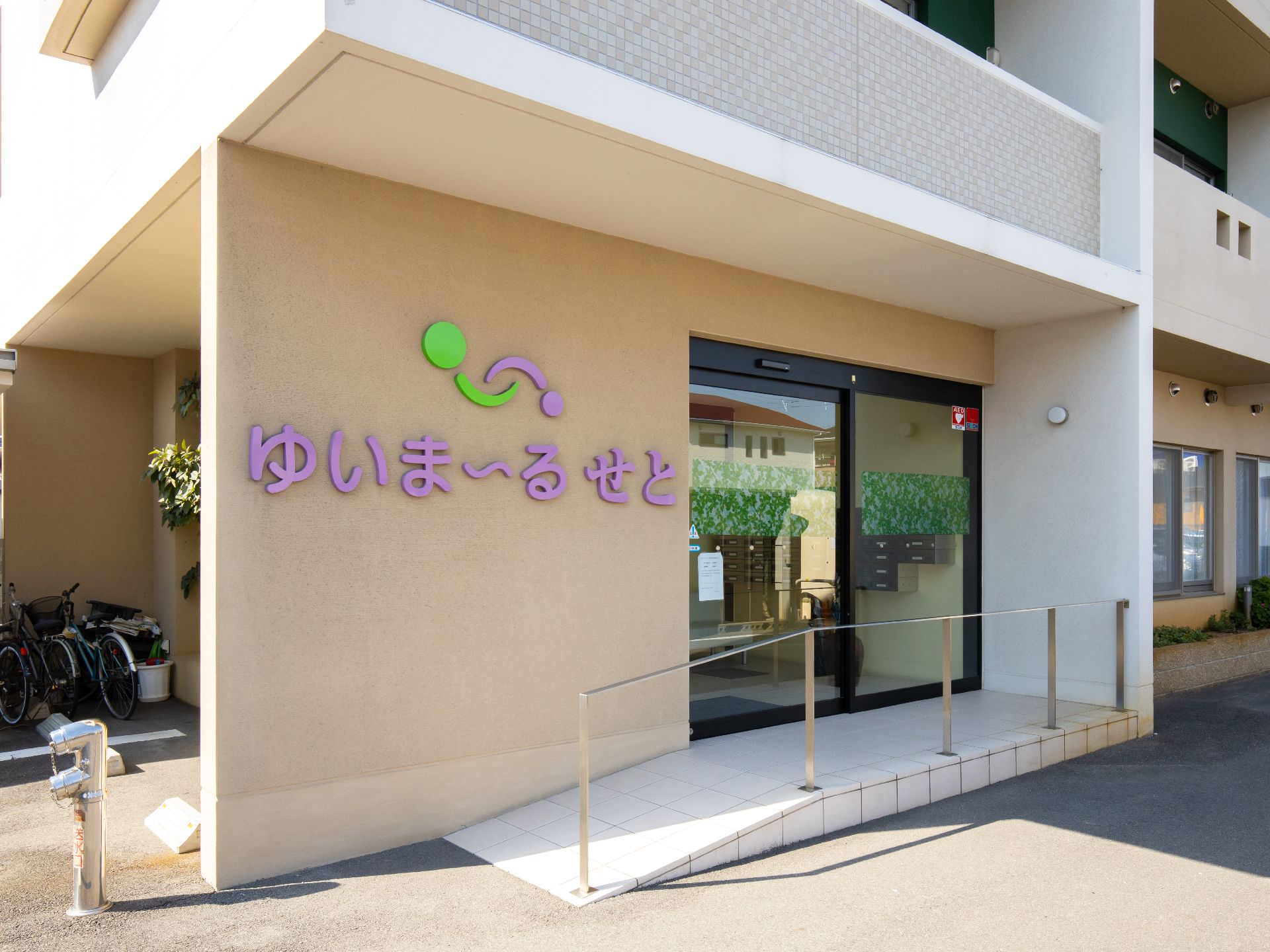 エントランスの通路は緩いスロープと手すりが設置されているので、車椅子をご利用の方も安全に通行することができる。