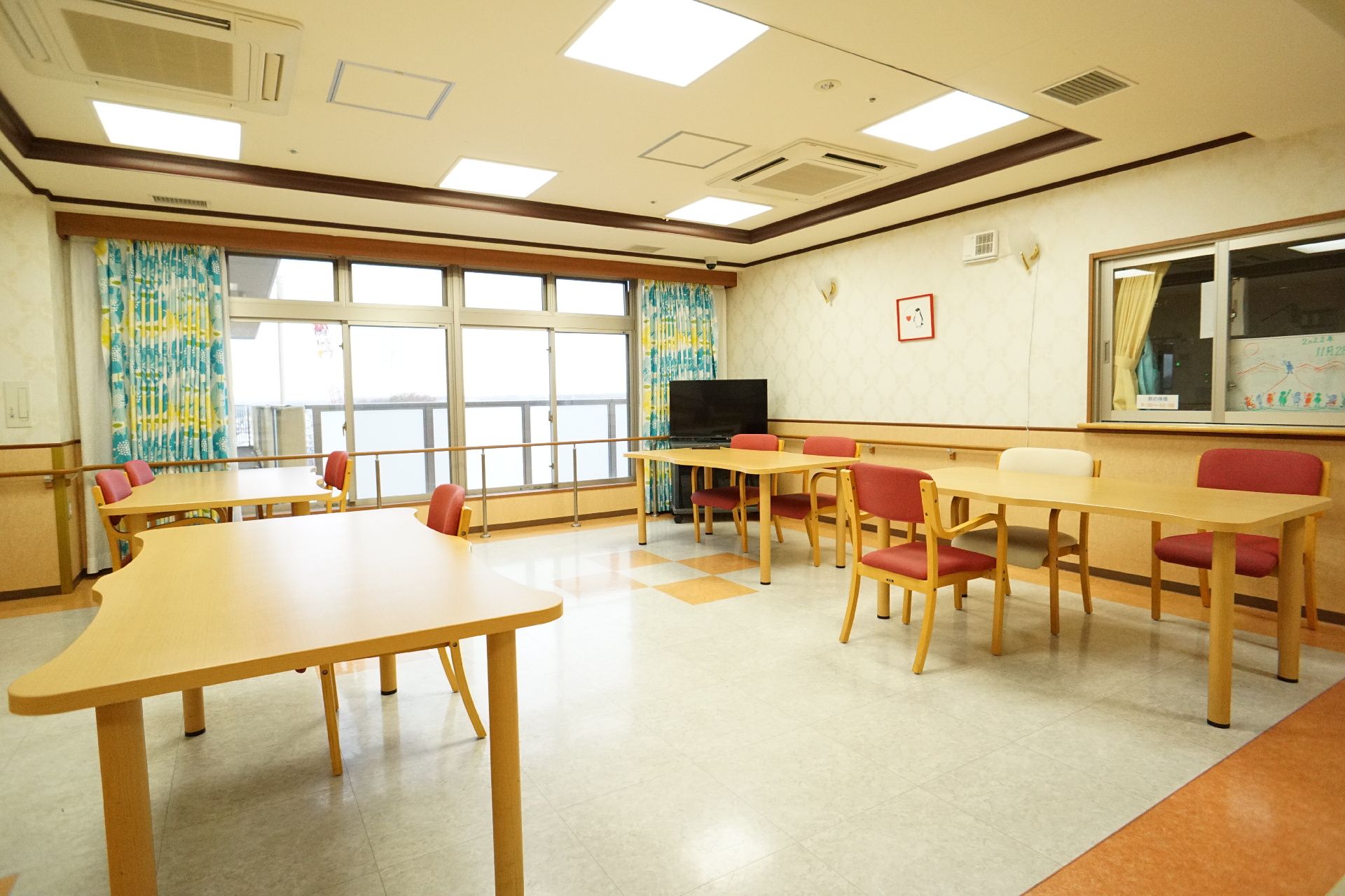 椅子と仕切り板がついているテーブルが設置された共有スペース