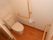 トイレは引き戸になっていて、簡単に開け閉めできるようになっている。手すりも設備され足腰が不自由な方でも安心できる。