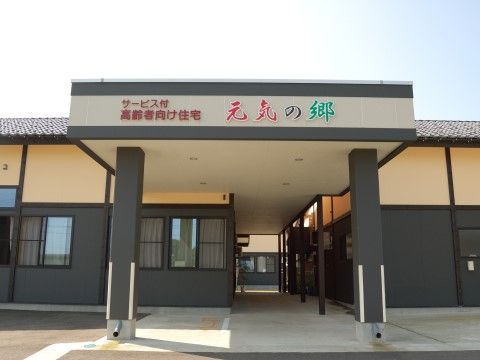 下半分が黒く、上部はベージュ色の和風の建物である。２本の柱が立てられた軒に施設の名称が表示されている。
