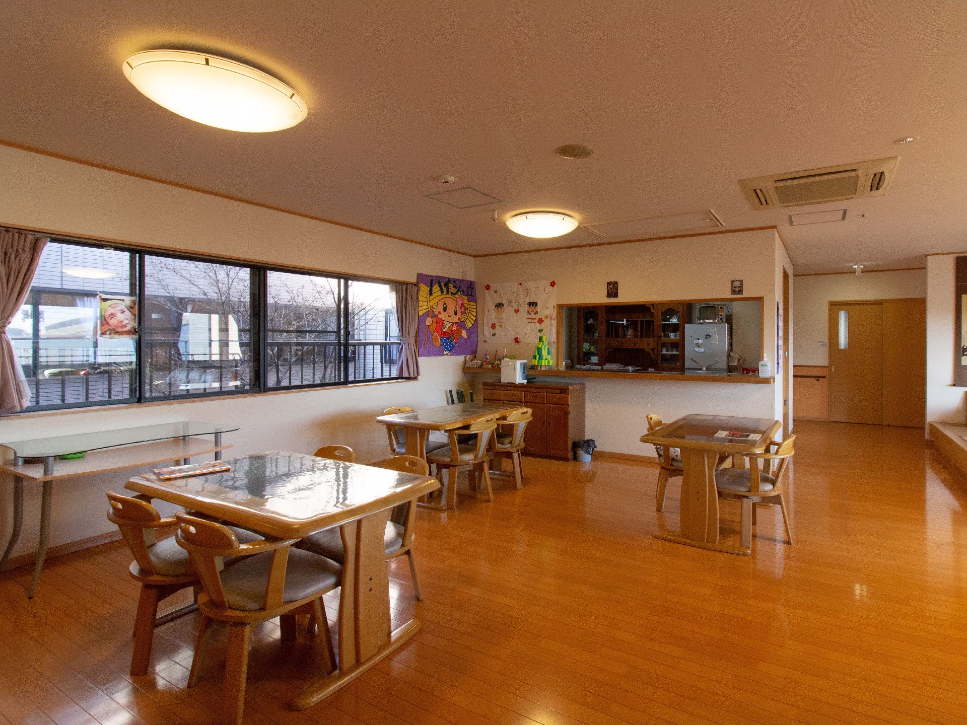 空間にゆとりを持たせたリビングである。４人掛けダイニングテーブルが配置されており、対面式キッチンが設けられている。