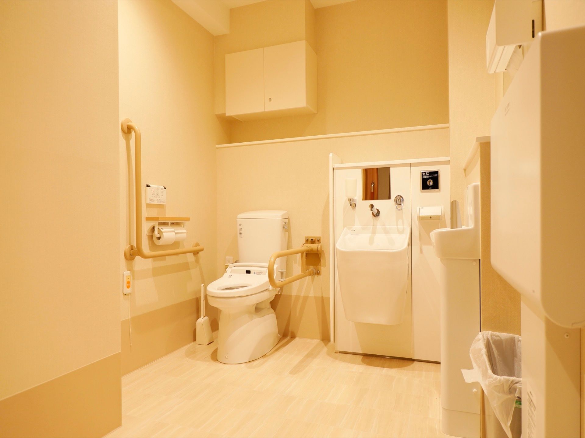 多目的トイレがある。広い空間で、安全に配慮した手すりやオムツ交換代が設置されている。どなたでも利用しやすい空間である。