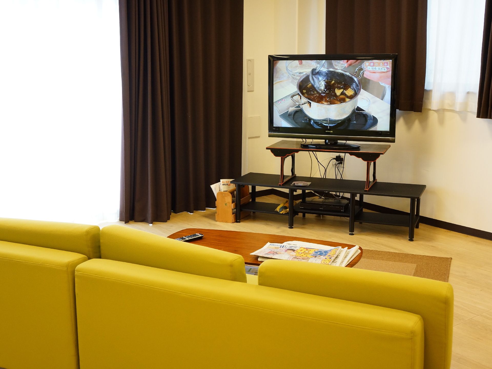 共用スペースのラウンジには、居住者のために大型のテレビが設置されている。また新聞なども置かれている。