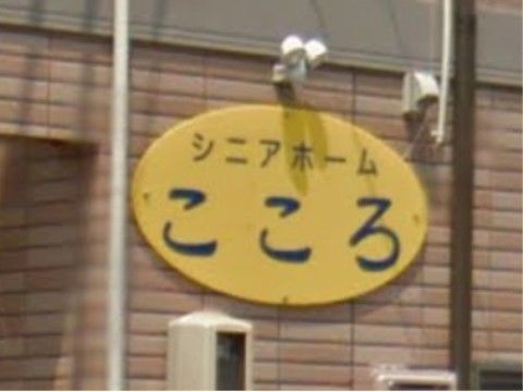 レンガ調の外壁に取り付けられている、施設名が書かれた看板