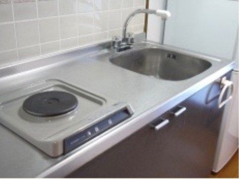 居室内にあるミニキッチン。シンクと、一口タイプの電磁調理器がある。シンク下は、収納スペースになっている。