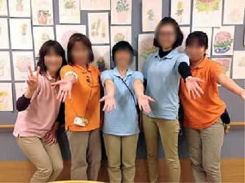 水色やオレンジなど、色鮮やかな制服を着ている５人の女性スタッフ