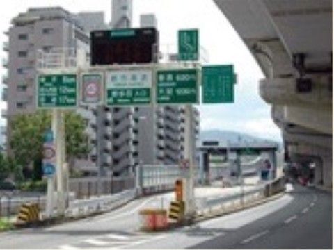 高速道路のインターチェンジの様子。後方には大きなマンションが見えている。施設の近くにあるため、来訪者様が車でアクセスするのに便利である。