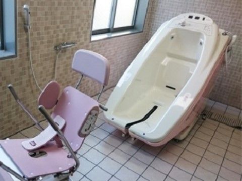 窓があり明るく清潔なタイル張りの浴室に、機械浴の設備が設置されている。椅子に座ったまま快適な楽に入浴できる。
