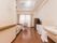 天井が高く、奥行きのある部屋になっている。壁には手すりがあり、洗面台もある。奥には介護用のベッド、タンスなどが置かれている。