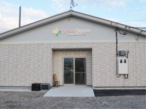 平屋造りで上部に施設名が掲げられている、スロープを設けた施設外観