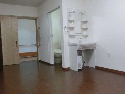 居室内に車椅子対応の洗面台、トイレが設置されている。居室の玄関、トイレの扉は開閉しやすい引き戸になっている。